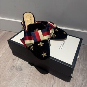 Gucci authentic Women's Black and Gold Star Mules with Red and Blue Ribbon heels